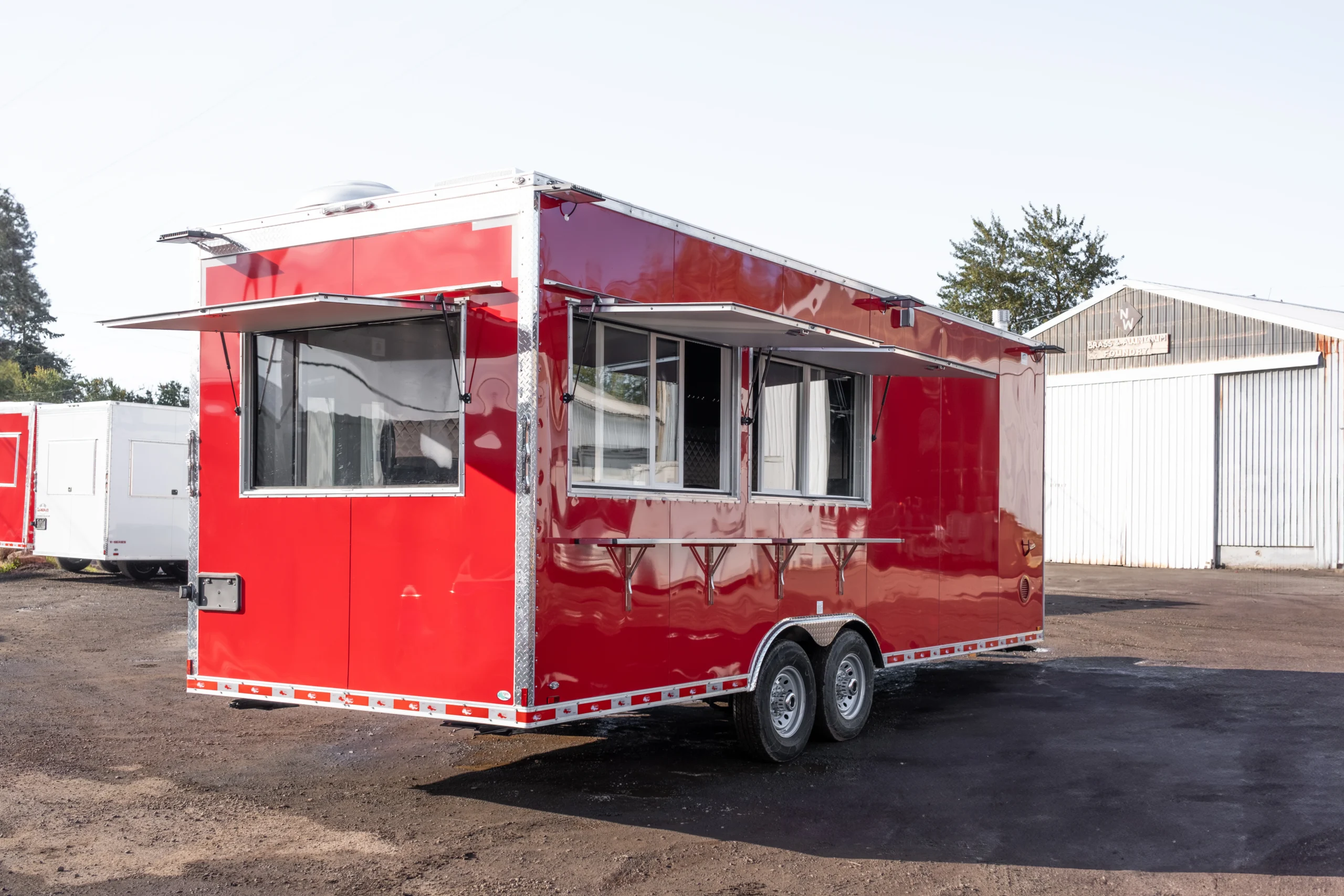 Custom food trailer with ventilation system, sinks, and commercial cooking equipment